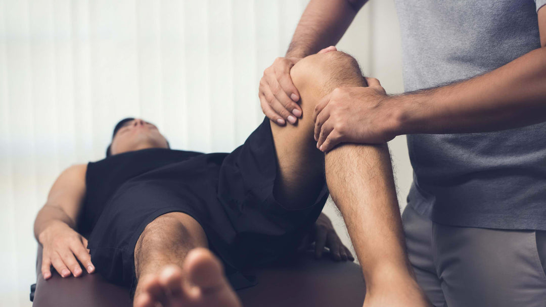 Physiotherapist treating athlete male patient.