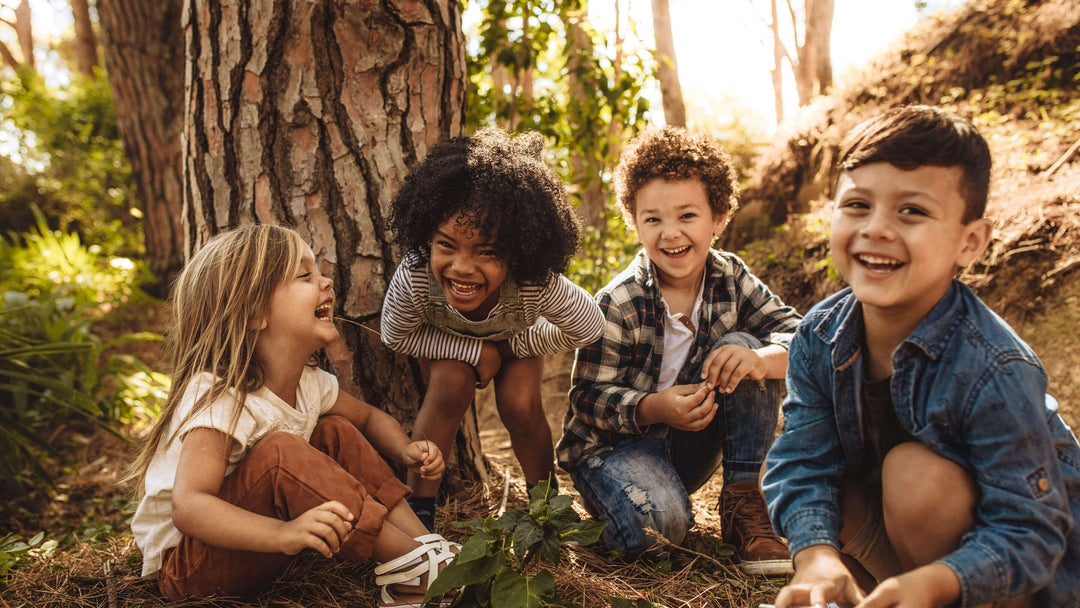 Group of cute multi-racial kids playing in forest