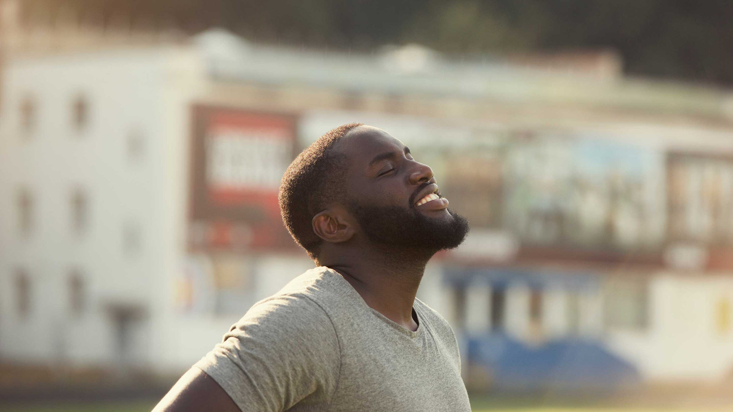 A handsome black man is feeling happy and relaxed.